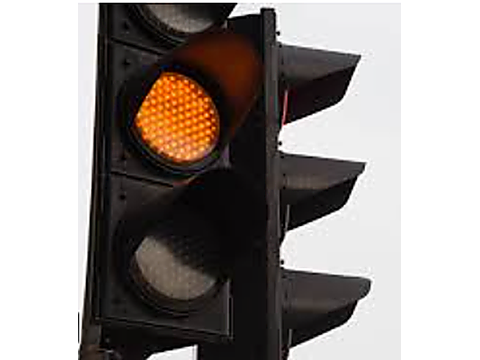Stop before the intersection unless stopping cannot be done safely — Alberta traffic-signals road sign for Class 7 test